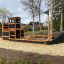 Skibet Natur - Legehus med sandkasse og rutsjebane på en legeplads