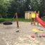 Lille Rutschetårn med rutsjebane og gynge i en legepark.