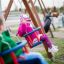 Børn leger på Gyngesæde: babygynge på legepladsen.