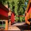Detailed view of Sørøverbyen play tower with slide, tunnel, and climbing wall surrounded by greenery